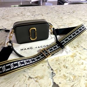 Marc Jacobs camera bag with black gold and silver metallic strap.